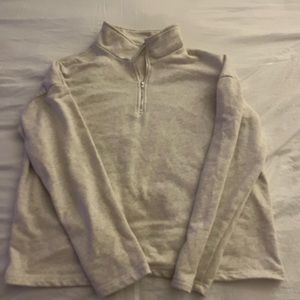 Crew neck. Zip up on neck.